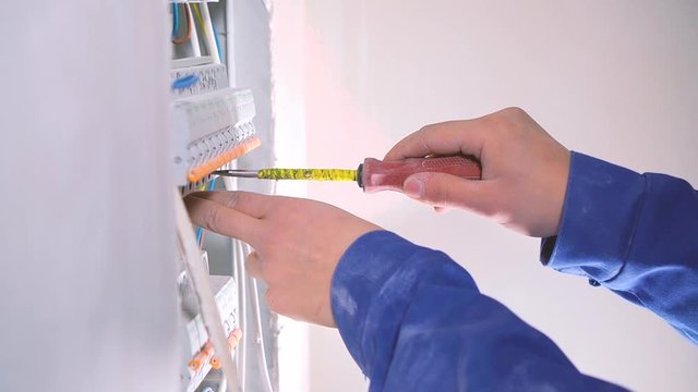 Electrician works with the electrical shield. 