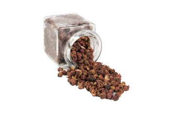 sichuan pepper in a glass jar isolated on white background. spices and food ingredients