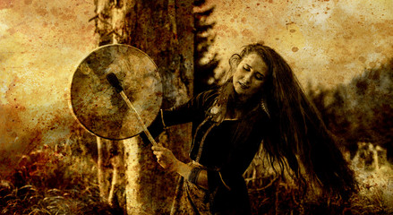 beautiful shamanic girl playing on shaman frame drum in the nature, old efect.