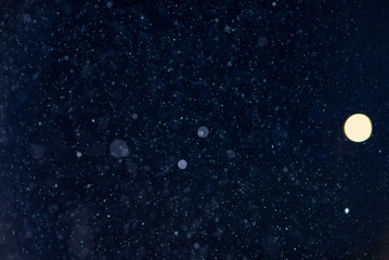 Abstract snow or rain bokeh texture overlay on blue background.