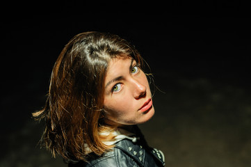 close night portrait of a pretty young woman with black hair and big green eyes