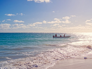 Motor boat with people is in the sea or ocean.