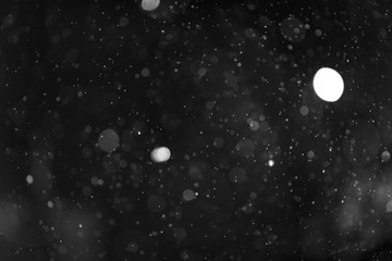 Snow or rain bokeh texture on black background