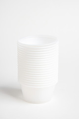 A stack of small plastic container for specimen medical laboratory testing set on a white background.