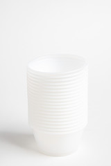 A stack of small plastic container for specimen medical laboratory testing set on a white background.