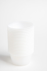 A stack of small plastic container for specimen medical laboratory testing set on a white background.