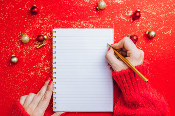 Christmas composition: notebook, pen, coffee cup and beans, fir branch on brown background. Woman's...