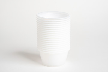 Obraz premium A stack of small plastic container for specimen medical laboratory testing set on a white background.