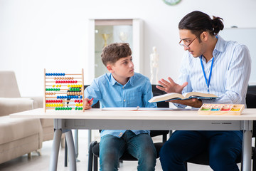 Young father helping his son to prepare for exam