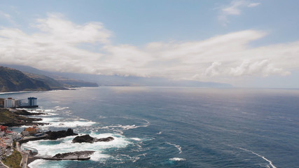 Aerial. Top view waves break on the coastline of Tenerife island