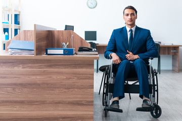 Young male employee in wheel-chair