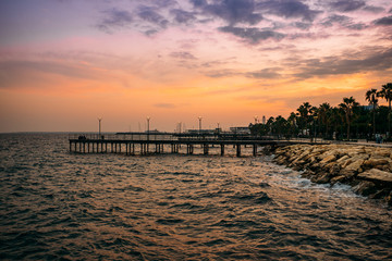 Obraz premium Pier at Molos Promenade park at sunset in Limassol city ,Cyprus. Beautiful evening mediterranean sea resort.