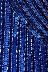 Fabric with sequins and sequins of bright colors. Fashion glitter fabric, sequins. Shiny surface