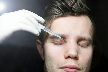 cosmetic procedure is the introduction of Botox to a man's face. Clinic of aesthetic surgery.