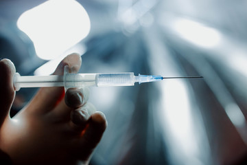 syringe with an injection in the hands of a doctor. concept.