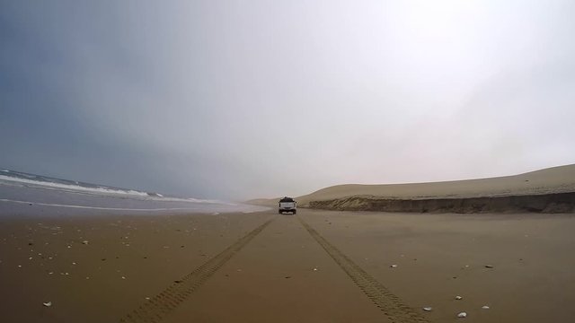 Safari 4x4 driving in the Namib desert by the Atlantic ocean on the skeleton coast, Namibia.