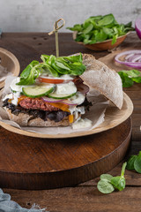 Healthy vegan burger with fresh vegetables and yogurt sauce