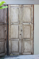 Ancient old wooden door on concrete background