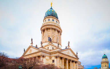 Obraz premium Night Christmas Market of Gendarmenmarkt in Winter Berlin, Germany. German street Xmas and holiday fair. Advent Decoration and Stalls with Crafts Items on the Bazaar.