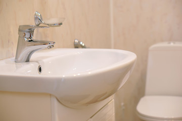 An example of installing a washbasin and toilet in one room. House, quarter, apartment or hotel