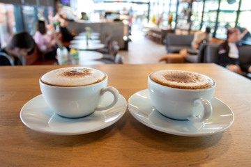 A cup of fragrant cappuccino coffee. In the morning in the cafe, coffee makes the body refreshed.