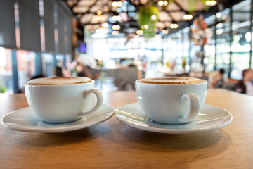 A cup of fragrant cappuccino coffee. In the morning in the cafe, coffee makes the body refreshed.