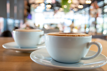 Fototapeta premium A cup of fragrant cappuccino coffee. In the morning in the cafe, coffee makes the body refreshed.