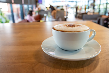 A cup of fragrant cappuccino coffee. In the morning in the cafe, coffee makes the body refreshed.