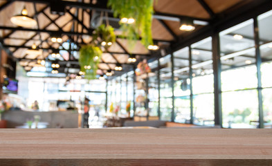 Wooden table top on blur cafe background