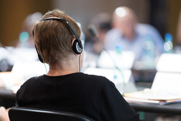 participant at international conference with headphones
