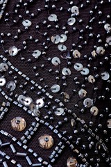 Fabric with sequins and sequins of bright colors. Fashion glitter fabric, sequins. Shiny surface