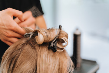 Fototapeta premium Hair stylist with blower work on woman hair