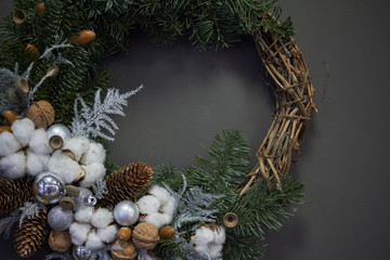 Christmas wreath of vines decorated with fir branches, Christmas balls and natural materials, New Year concept