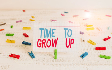 Handwriting text writing Time To Grow Up. Conceptual photo knowing that you are mature demonstrating have responsibility Green clothespin white wood background colored paper reminder office supply