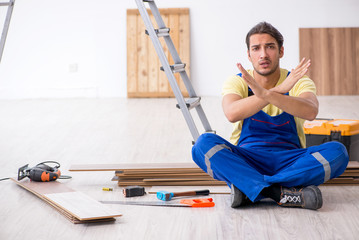 Young male contractor working indoors