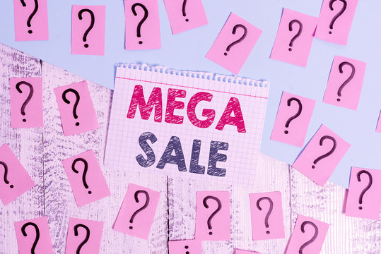 Text sign showing Mega Sale. Business photo showcasing The day full of special shopping deals and heavy discounts Scribbled and crumbling papers with thick cardboard above wooden table