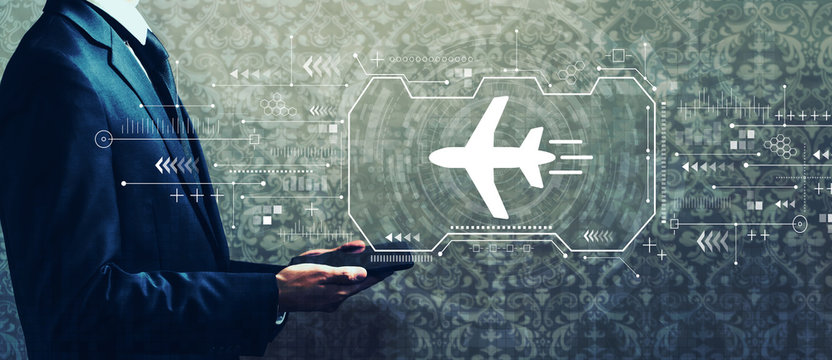 Airplane travel theme with businessman holding a tablet computer - Powered by Adobe