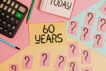 Conceptual hand writing showing 60 Years. Concept meaning It is the onset of a golden era Commemorating a special day Mathematics stuff and writing equipment on pastel background