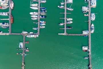 Aerial View Top down Drone shot of Yacht and sailboat parking  in marina Transportation and travel background concept