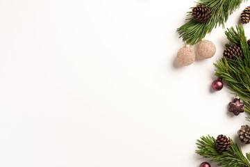 Christmas composition. Spruce branches with cones and christmas decorations, on a white background. Flat lay, top view, copy space.