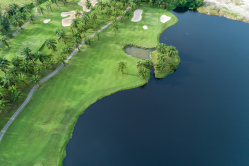 Aerial view drone Top down shot of beautiful green golf field and palm trees High angle view in summer time