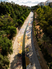 cement irrigation canal with vinalopo river colors as it passes through elche