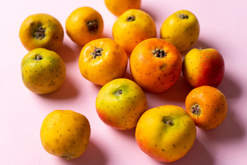 Mexican tejocote fruit on pink background