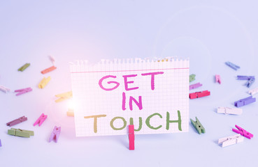 Word writing text Get In Touch. Business photo showcasing Stay in contact Constant Communication Interaction Bonding Colored clothespin rectangle square shaped paper light blue background