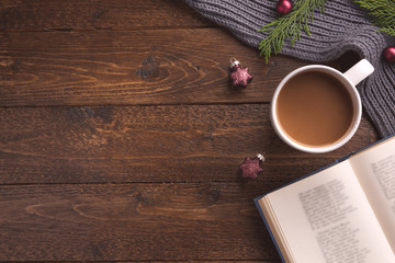 Fototapeta premium Christmas decoration, book and cup of coffee on wooden background, flat lay. Space for text.
