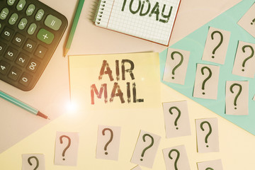 Conceptual hand writing showing Air Mail. Concept meaning the bags of letters and packages that are transported by aircraft Mathematics stuff and writing equipment on pastel background