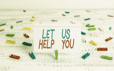 Handwriting text writing Let Us Help You. Conceptual photo Offering a service to someone to help him in his necessity Green clothespin white wood background colored paper reminder office supply