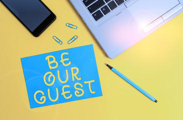 Conceptual hand writing showing Be Our Guest. Concept meaning You are welcome to stay with us Invitation Hospitality Trendy open laptop smartphone marker paper sheet clips