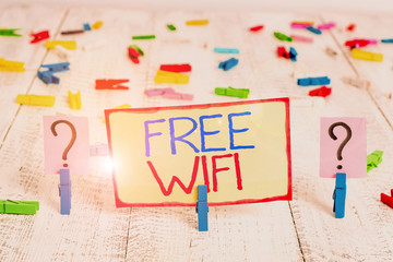 Word writing text Free Wifi. Business photo showcasing let you connect to the Internet in public places without paying Scribbled and crumbling sheet with paper clips placed on the wooden table