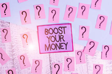 Handwriting text Boost Your Money. Conceptual photo increase your bank saving using effective methods Scribbled and crumbling papers with thick cardboard above wooden table